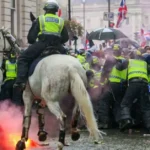 Elon Musk’s speech at the Unite the Kingdom march triggers outrage as violence erupts in London, leaving police officers injured.